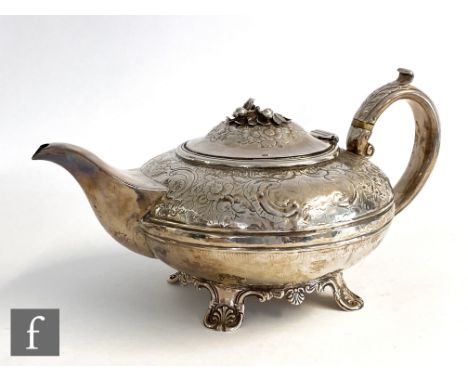 A George III hallmarked silver teapot of footed melon form with embossed floral decoration and ivory detail on the handle, he