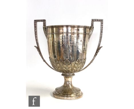 A Victorian hallmarked silver twin handled trophy, circular foot with still leaf decoration below ancathus leaf border and pr