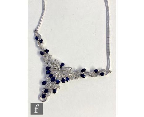 A silver and white gold plated sapphire and diamond set necklet with twenty individually set sapphires highlighted with diamo