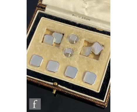 An early 20th Century 9ct white gold and canted square mother of pearl dress stud set, comprising cufflinks and six studs, to