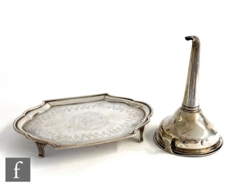 A Georgian hallmarked silver cushioned oval tea pot stand with bright cut decoration and raised on four scroll feet, length 1