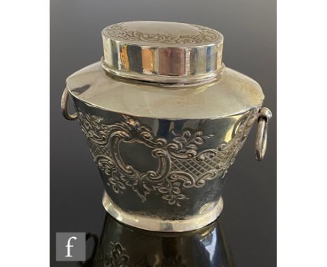 A silver hallmarked tea caddy of tapered oval form, with embossed floral and scrolling decoration below ovoid pull off cover,