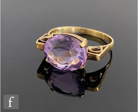 A 14ct single stone amethyst ring, oval facet cut claw set stone within gold block highlighted shoulders, 3.3g, ring size N, 