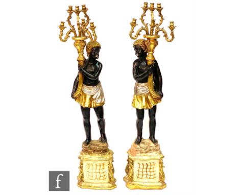 A large pair of 20th Century 'blackamoor' figures each holding a six branch candelabrum, painted in traditional colours and w