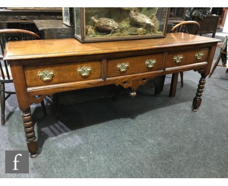 A late 19th to early 20th Century constructed oak dresser in the 18th Century style, fitted with three frieze drawers above a