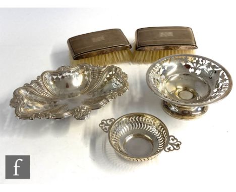 A small parcel lot of hallmarked silver items to include three bon bon dishes of various shapes and decoration and two hairbr