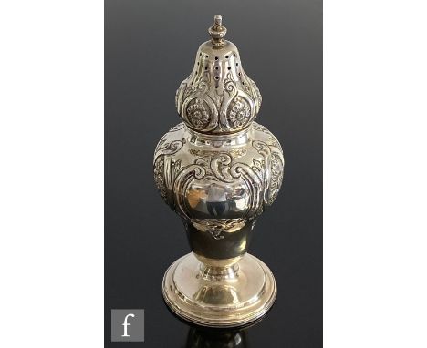 A hallmarked silver sugar castor of baluster form with part embossed foliate decoration, height 17cm, weight 5oz, Birmingham 