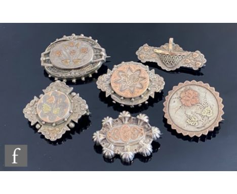 Five 19th Century and later silver and gold brooches each with a stylised floral design, largest width 4.5cm, three hallmarke