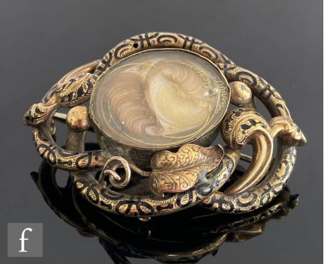 A mid 19th Century part gold memorial brooch with gold reverse to a central plaited hair panel within a black enamel highligh