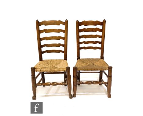 A near set of eight early 20th century ash and rush seat ladder back dining chairs including an elbow chair. (8) 