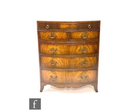 A 20th Century mahogany bow-fronted Georgian style bachelor's chest, with a compartmental fitted frieze drawer above two shor