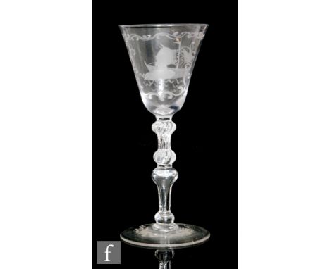 An 19th Century drinking glass in the 18th Century Newcastle Baluster style with a round funnel bowl engraved with a portrait