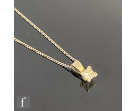 A 9ct white gold diamond pendant, princess cut claw set stone, weight approximately 0.50ct, suspended from a silver trace cha