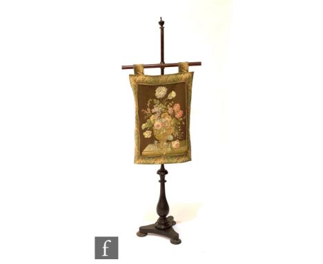 A 19th Century mahogany pole screen with later floral tapestry panel, height 142cm. 