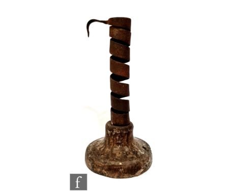 An 18th Century rat de cave candlestick, on turned wooden base, height 19cm. 