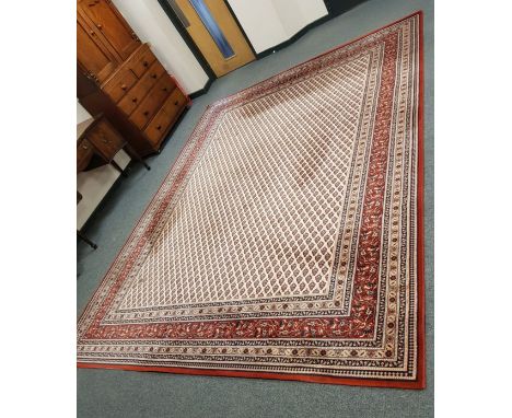 A machine made carpet of Persian design, 404 cm x 305 cm