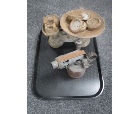 A set of vintage kitchen scales with weights and a blow lamp 