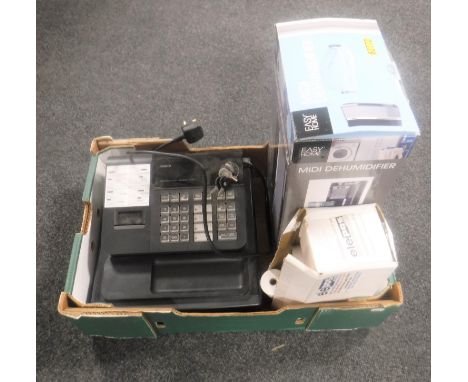 A box containing Casio cash register with keys and till rolls together with a boxed de-humidifier 