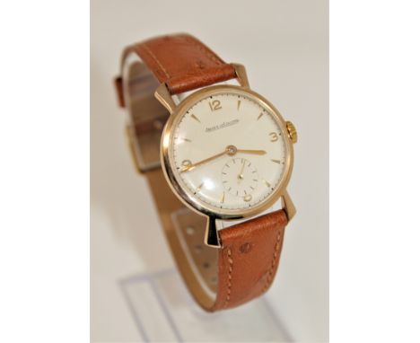 A gents vintage 9ct gold Jaeger LeCoultre wristwatch, silvered dial with Arabic and baton numerals and subsidiary seconds, le