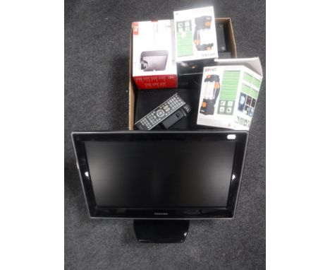 A box containing a desk top hard drive, two outdoor camping lights, Panasonic HD box, Polaroid micro hifi system, together wi