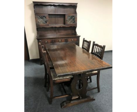 An oak refectory dining table together with a set of four oak tapestry seated dining chairs 