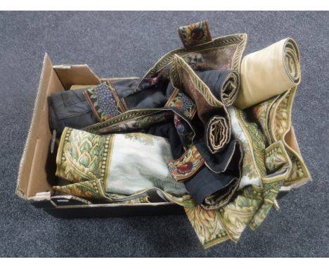 A box containing seven tapestry wall hangings 