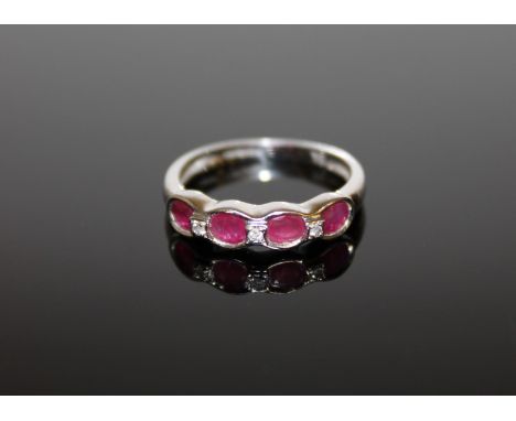 A 9ct white gold ruby and diamond ring, size N