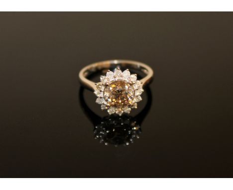 A 14ct white gold diamond cluster ring, the central brilliant-cut cognac-coloured diamond weighing 1.51 carat, of SI/P1 clari