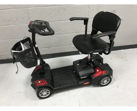 A Drive Scout mobility scooter with keys, manual and charger