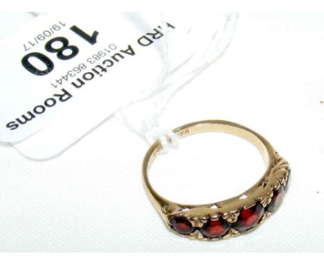 A 9ct yellow gold garnet dress ring