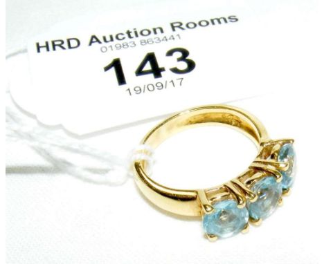 An 18ct yellow gold blue zircon three stone ring