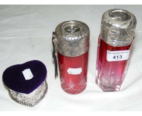 Two continental cranberry glass silver top cologne bottles and an embossed silver heart shaped trinket box with lined interio