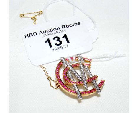 An 18ct gold multi-stone ruby and diamond "MCC" brooch, complete with safety chain