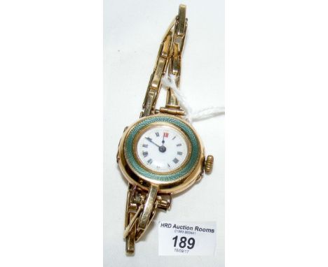 A 9ct gold cased lady's wrist watch with green enamel decoration and 9ct gold expanding bracelet