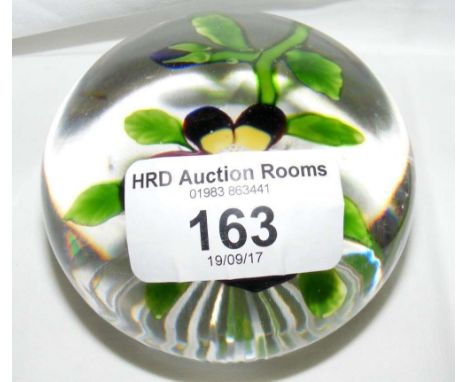 A floral lamp work paperweight with star cut base