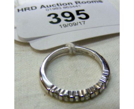 An 18ct white gold diamond half hoop eternity ring