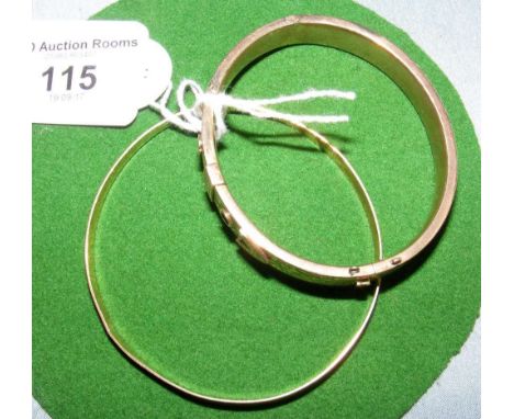 An engraved yellow metal bangle and a 9ct gold ditto