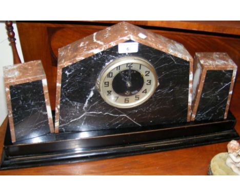 An Art Deco marble mantel clock with matching pedestals on wooden base