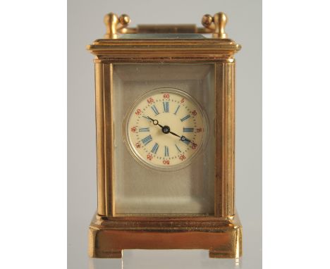 A MINIATURE GILT FACED CARRIAGE CLOCK. 2ins.