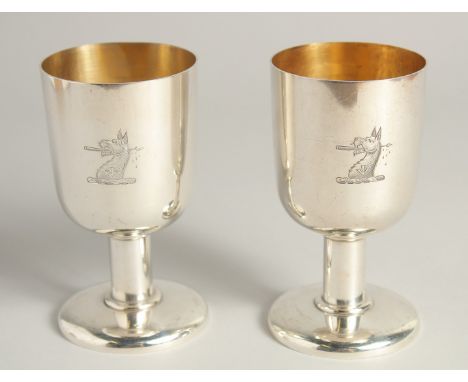 AN EXCELLENT PAIR OF SILVER GOBLETS BY R. J. J. with gilt interior.  Griffin crest. 4.75ins high, weight 12ozs.