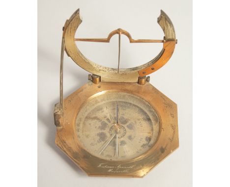 A GEORGIAN OCTAGONAL BRASS TRAVELLING COMPASS with silvered dial. Made in Paris. 3.75ins in a leather travelling case.