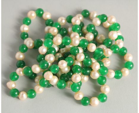 A STRING OF JADE AND PEARL BEADS. 48ins long.