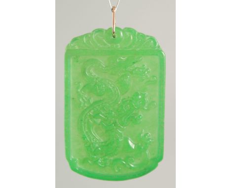 A GOLD TOP DRAGON JADE PENDANT. 2ins.