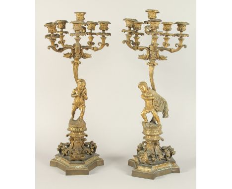 A GOOD PAIR OF 19TH CENTURY FRENCH ORMOLU SIX LIGHT CANDELABRAS with dwarf figures on a base with marble. 23ins high.