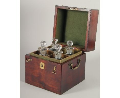 A GOOD GEORGIAN SQUARE MAHOGANY DECANTER BOX AND COVER with brass carrying handle and filled with four glass decanters and st