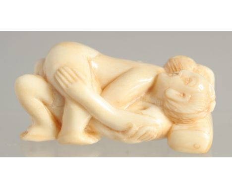 A CARVED BONE EROTIC NETSUKE. 2ins long.