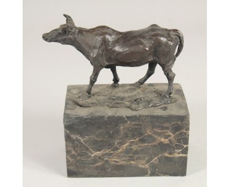 A SMALL BRONZE OF A BULL 5ins long on a marble base.