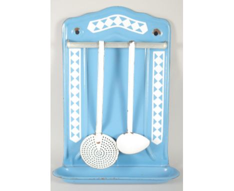 A BLUE AND WHITE TIN SKIMMER AND LADLE on a stand. 17ins long