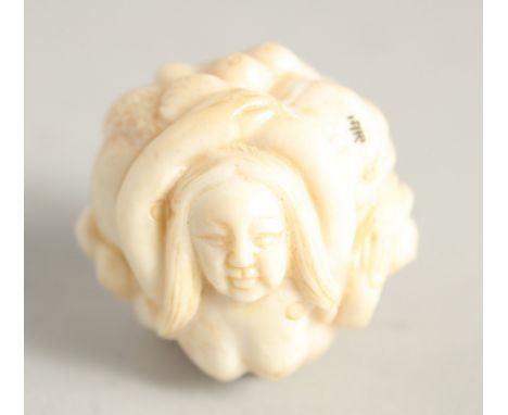 A CHINESE CARVED BALL NETSUKE "NUDE". 1.25ins diameter.