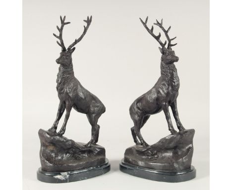 AFTER J MOIGNIEZ A PAIR OF BRONZE STAGS on an oval marble base.